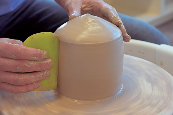 4 Use a firm, straight-sided rib to straighten the side walls.