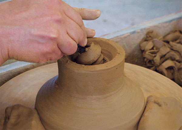 5 Cut out the middle of the foot while using the extra clay on the outside as support.