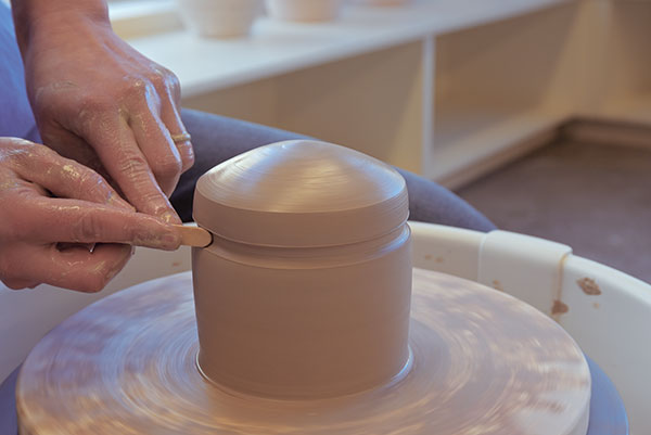 6 As the wheel is turning, create a groove that will become the lid seat.