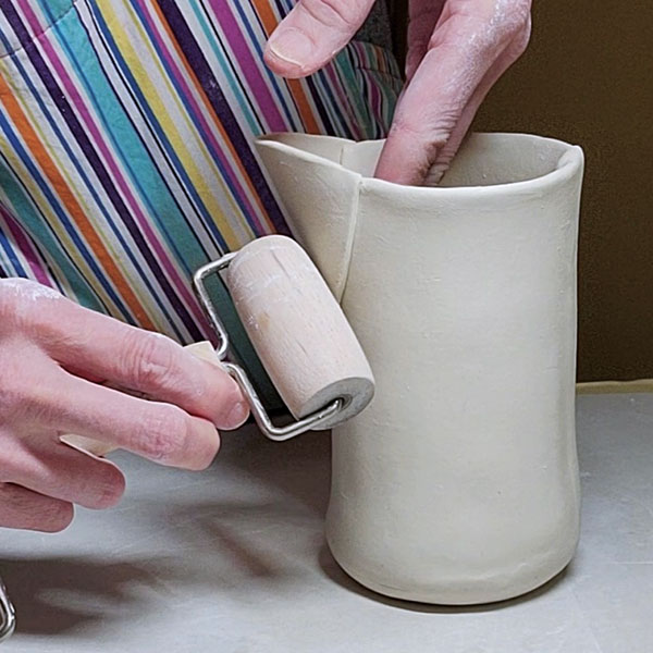 9 Attach the spout to the pitcher and compress the seams with a roller.