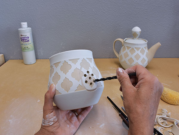 9 Drill holes where the teapot spout is going to be attached.