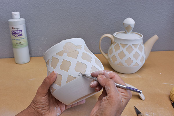 7 Remove the dried glaze where the handle will be attached.