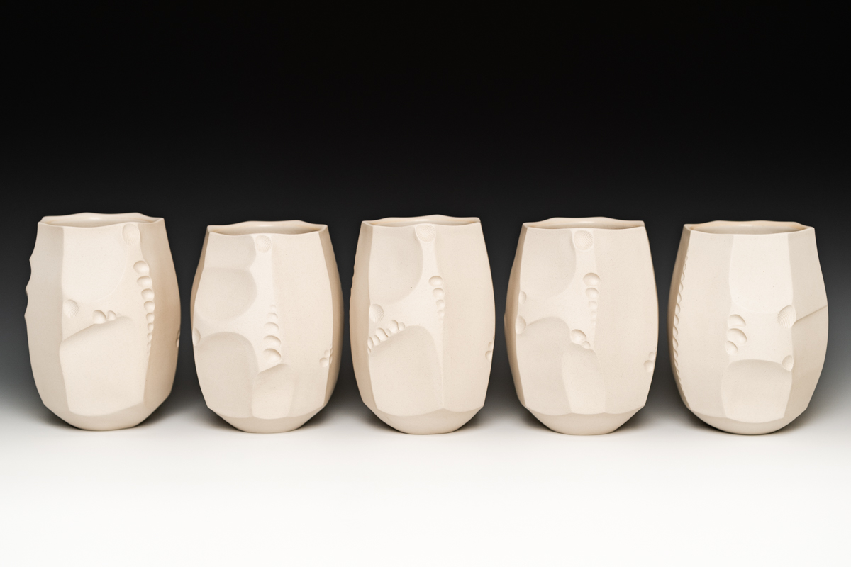 Alex Olson’s faceted and textured tumblers, 5¼ in. (13 cm) in height, B-mix clay, clear crackle liner glaze, fired to cone 6 in oxidation, 2020.