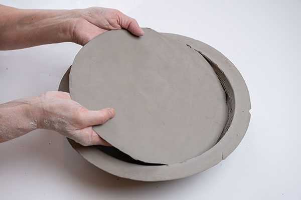 11 Use a compass to draw a circle below the rim of the foot section; repeat on paper to make a template for cutting a slab to fit.