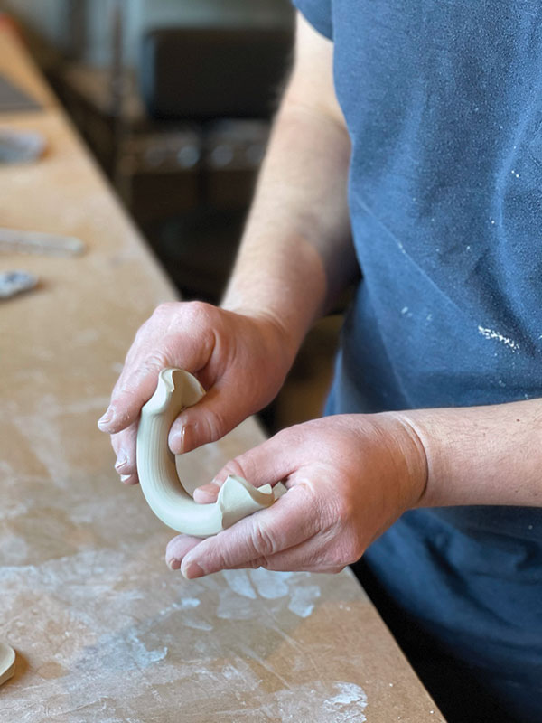 8 Bend the handle into a half circle and prepare for attachment.