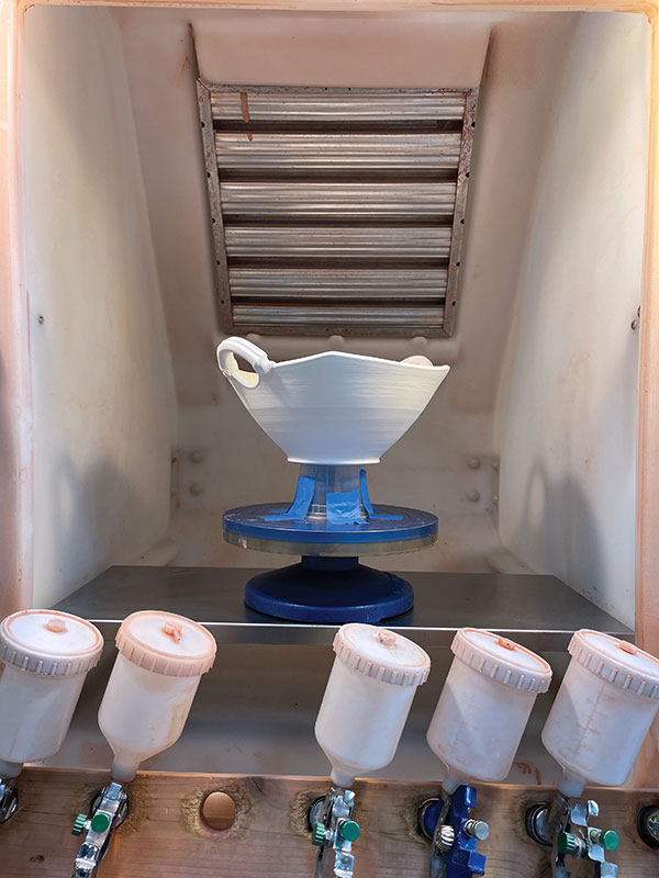 13 The spray booth is prepared with the handled bowl on a raised surface on a banding wheel for spinning. The raised base allows for spraying both the outside and inside surfaces without flipping the bowl over.