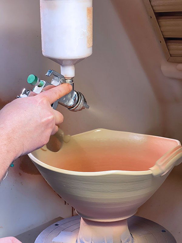 15 This is a simple glaze combination consisting of only two colors, so the top color is applied overlapping the first. It’s applied very thick, which induces running over the bottom glaze. Make sure to spray glaze around all sides of the handles, too.
