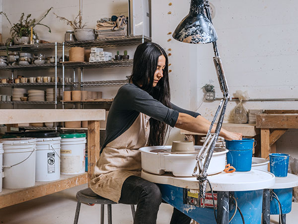 4 Natasha Alphonse throwing mugs in the studio. Photo: Kyle Johnson.