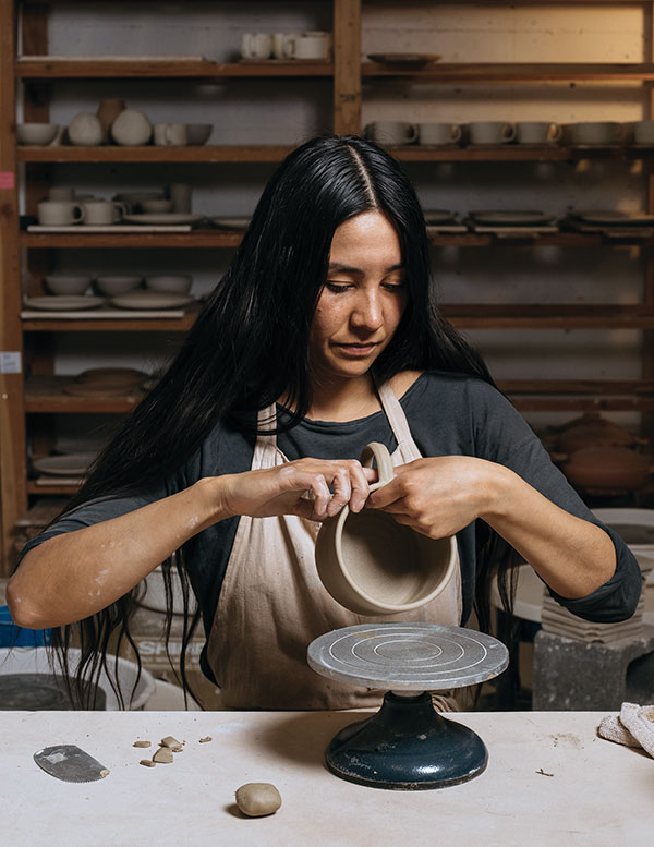 2 Natasha Alphonse attaching a handle to a mug. Photo: Kyle Johnson.