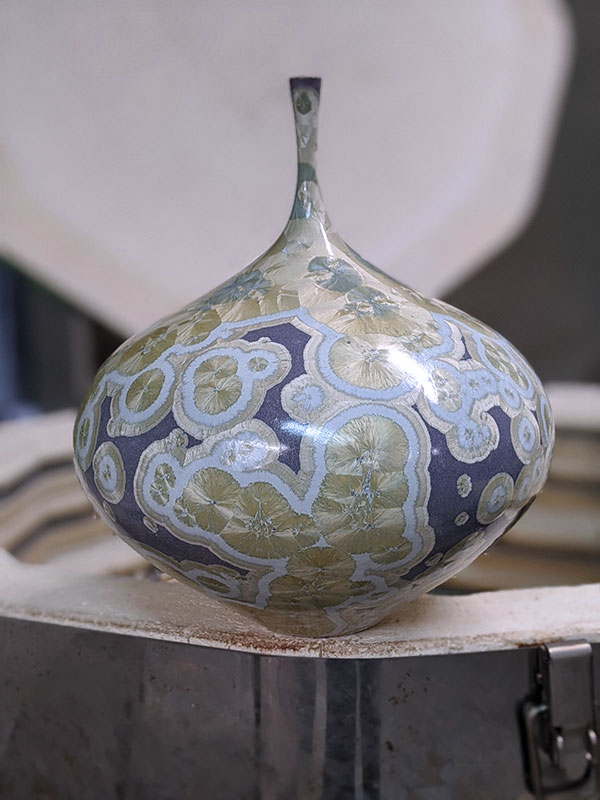 6 Drew Darley’s gold and purple crystalline bottle, 12 in. (30 cm) in width, wheel-thrown porcelain, crystalline glaze, fired to cone 11 in oxidation, post-firing reduction.