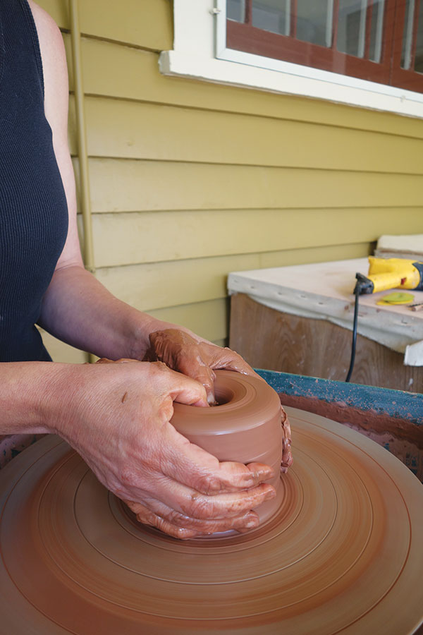 1 Center and open 4 pounds of stiff clay, then pull up the walls to create a tall, narrow cylinder.