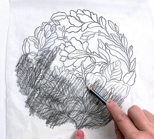 2 Shade the back of the paper with graphite to prepare to transfer the design onto the plate.