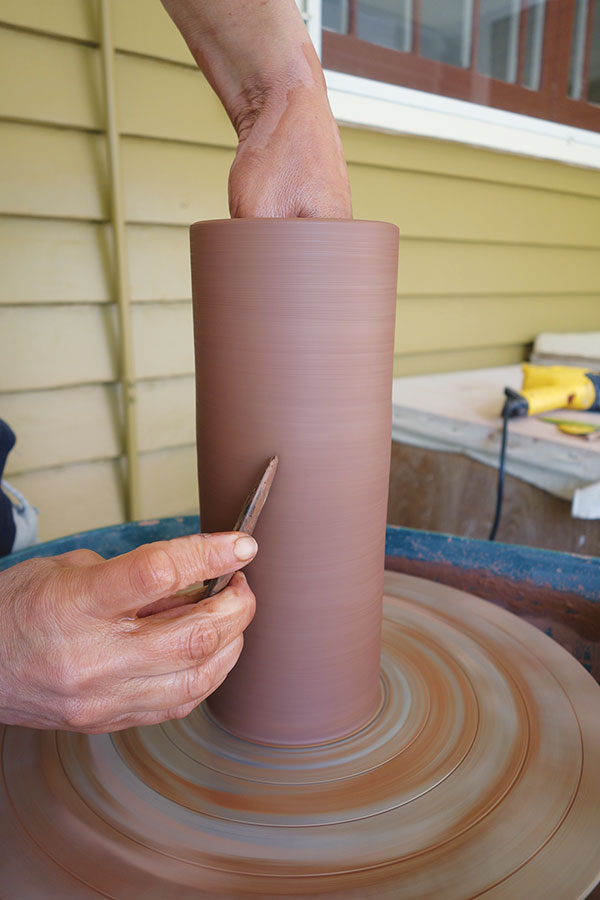 4 Compress the exterior with a rib to remove any throwing slip and to ensure the wall is smooth and flat.