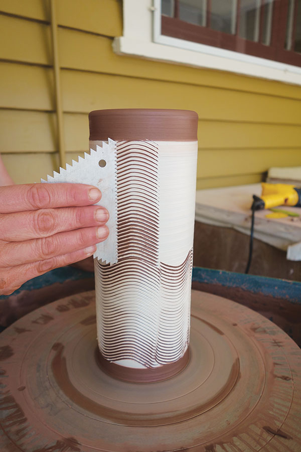 7 If needed, make a second swipe with the cake-decorating comb above the first to cover the slip area.