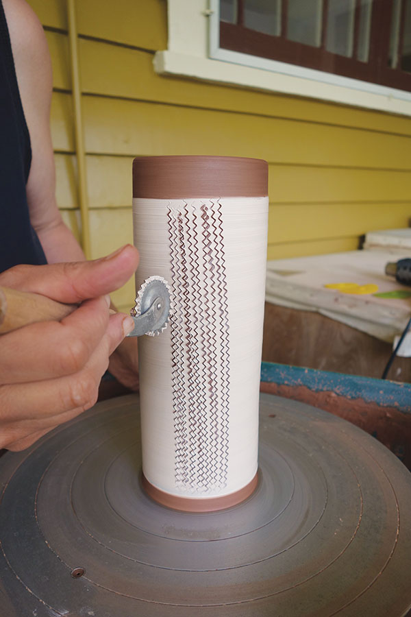 8 With the wheel stopped, roll the fluted pastry wheel vertically up the cylinder in repeated rows.