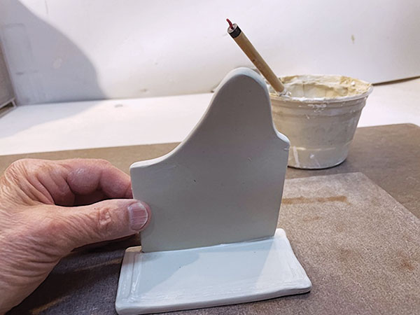 9 Place the mountain-shaped piece on the base, saving space on either side.
