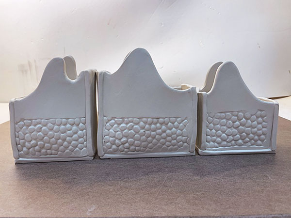 11 Add dimension by gently bellying out the mountain-shaped pieces.