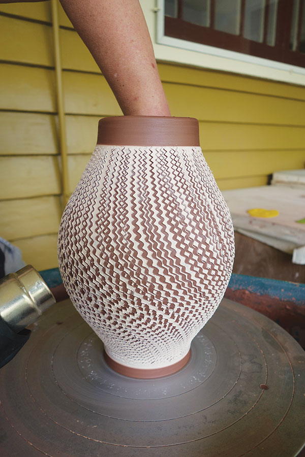 13 Stiffen the clay with a heat gun, as needed, to prevent the pot from collapsing while continuing to stretch.