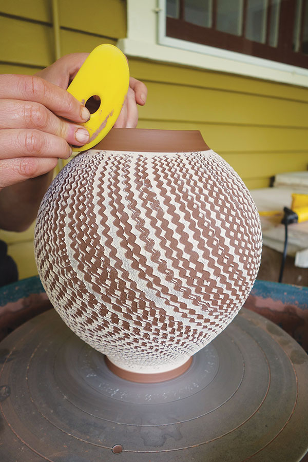 15 Refine the neck with your fingers, a sponge, or various ribs to create the shape you desire.