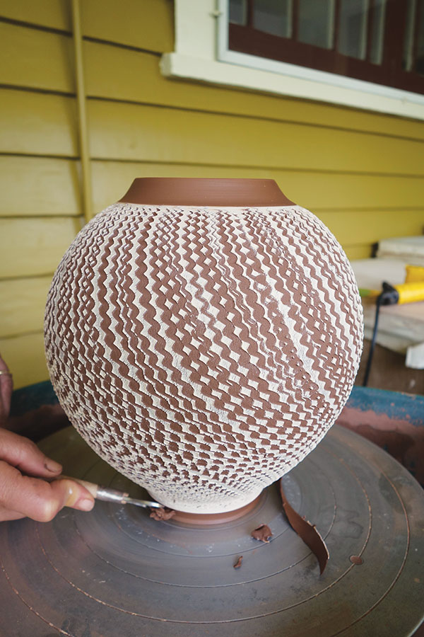 16 Trim the base with a loop tool. Prevent sagging at the base by stiffening the clay with a heat gun as you trim.