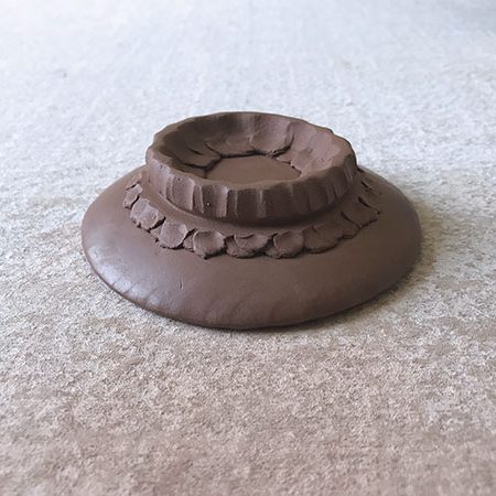 4 The indented and compressed channel around the exterior of the leather-hard foot ring.