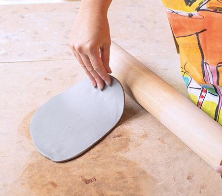 3 Roll colored-clay slabs. Rotate and flip the slabs to ensure they stretch evenly.