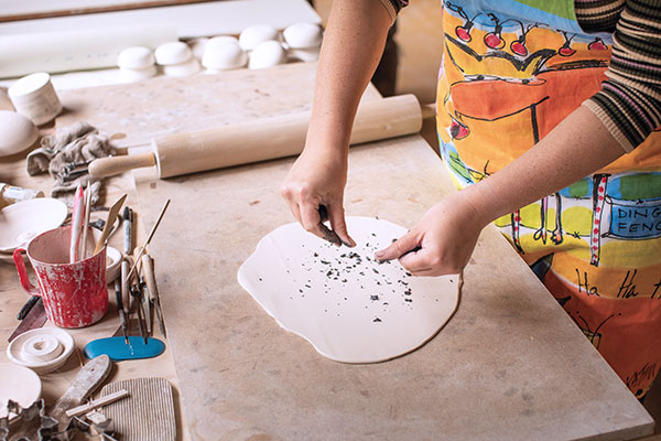4 Rub slip-coated fingers over a colored slab to make crumbs, then roll to embed.