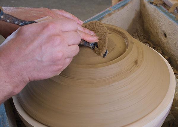 5 Once the bowl is leather hard, begin trimming by establishing the foot and cutting out the clay inside the foot ring.