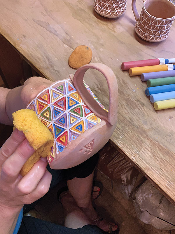 6 Use a damp sponge to wipe away any excess underglaze.