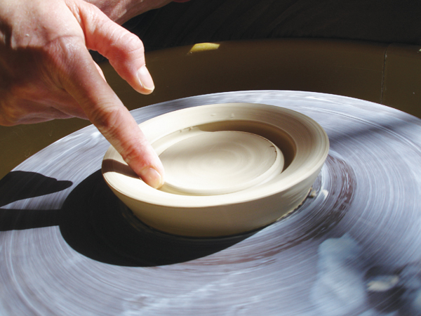 5 Smooth the edges of the foot-ring valley with your finger, then dry and bisque fire the puki.