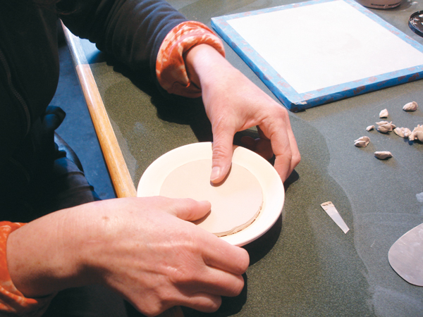 8 Score, add slip, then drop the base of the pot onto the puki, and press lightly to attach the foot ring.