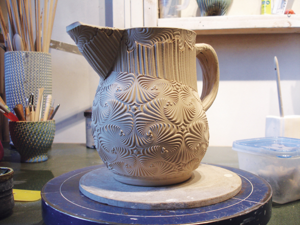 12 Before any drying occurs, remove the pot from the puki and refine the shape and finish the pot.