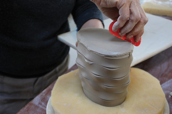 6 Turn the basket over, support it on foam, and use a rubber rib to compress the slab onto the base of the basket.