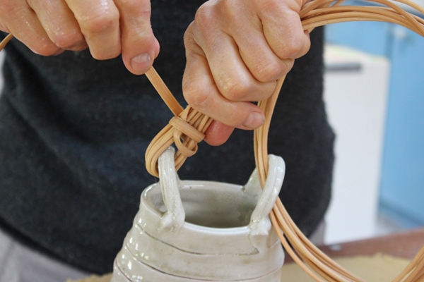 15 Hold the overlapped round reed tightly around the lug and start wrapping it snugly with the flat reed.