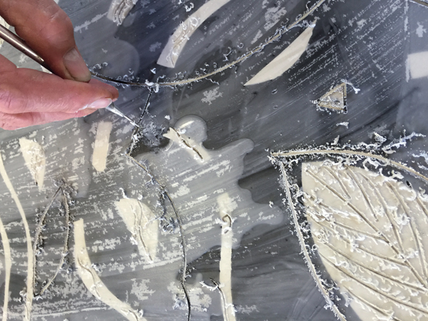 16 Bosch uses a needle tool to etch a drawing through wax. 