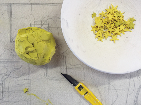21 Star shapes are cut out of a yellow-colored fusion clay.