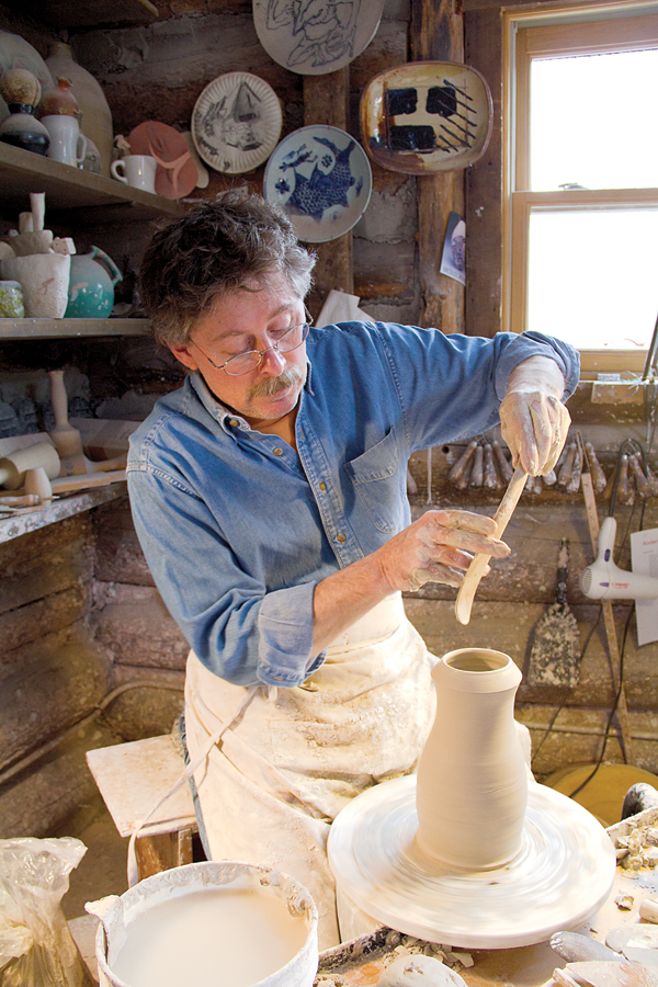 1 Casebeer throwing a pitcher with a wooden throwing stick, 2015. Photo: Brianna Horn, Anderson Ranch Arts Center.