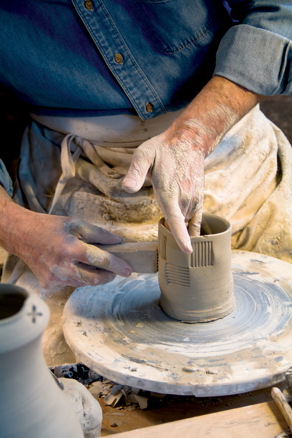 2 Casebeer using a wooden stamp on a tea bowl, 2015. Photos: Brianna Horn, Anderson Ranch Arts Center.