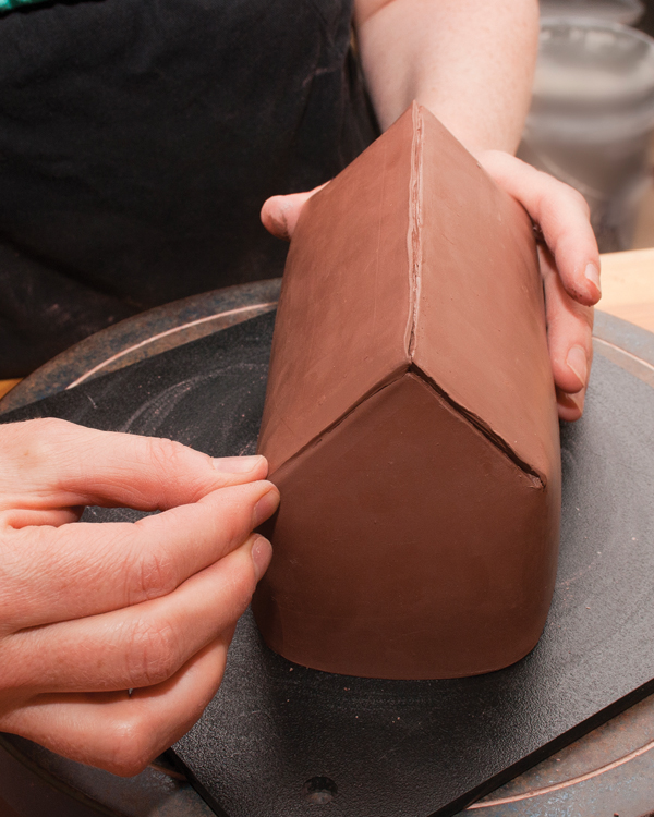 5 Starting at the peak, pinch the edges together between your fingertips, working downward to the eaves.