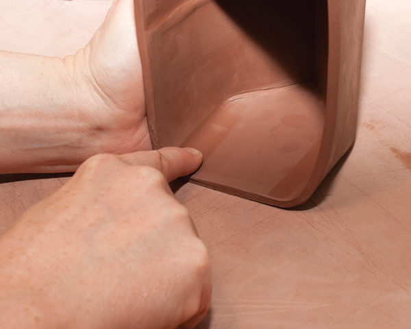 6 Lay the form on its side and press your finger in a steady line motion along the corners to accentuate the shape.