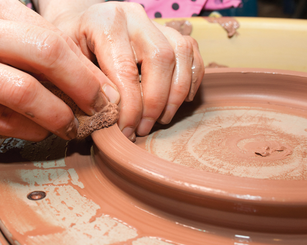 13 Throw a bottomless ring on the wheel. Compress it while slowly pulling the ring outward to create a wall for a tray.