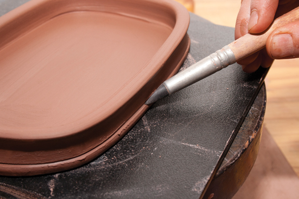 14 Create a ridge to accentuate the slab foot, designate a place for waxing, and slow glaze runoff.