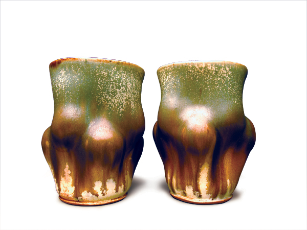 2 Herrick Smith’s pair of tumblers, to 7 in. (18 cm) in height, wheel-thrown and altered stoneware, fired to cone 10 in a reduction kiln.