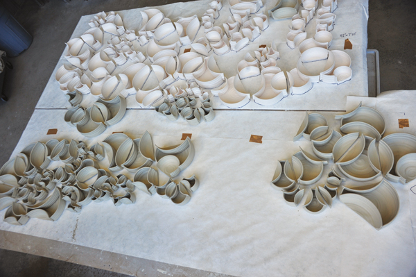 3 Combining sections. The top section has bisque-fired pieces. The lower section has greenware and a third section starts to overlap creating a transition between them.