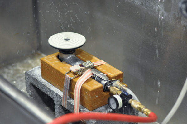 3 The complete grinder assembly strapped to a cement block set in the sink.