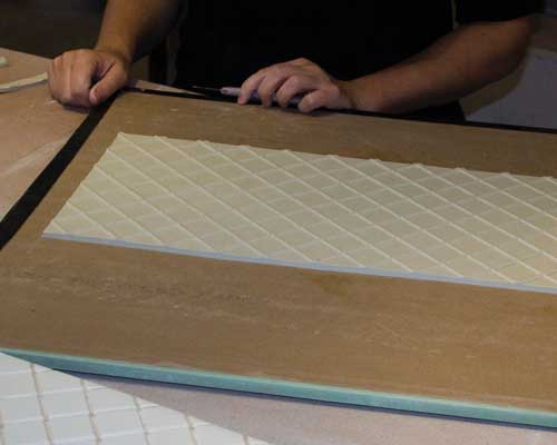 4 The trimmed slab showing the raised line formed from the carved plaster mold.
