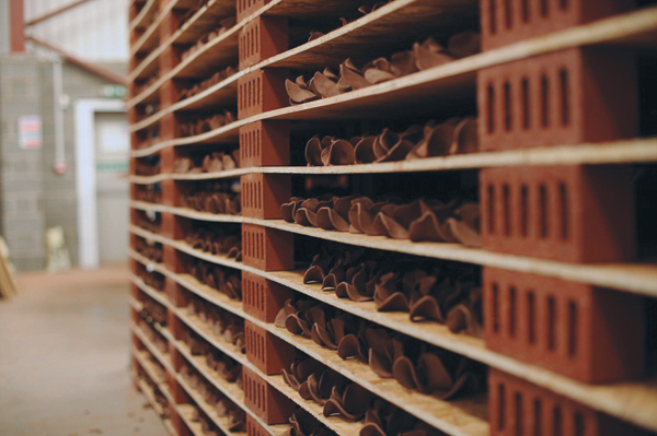 5 Poppies drying in single layers on makeshift shelving in Paul Cummins' Derby workshop before they were bisque fired. Approximately 7000 poppies were made each day.