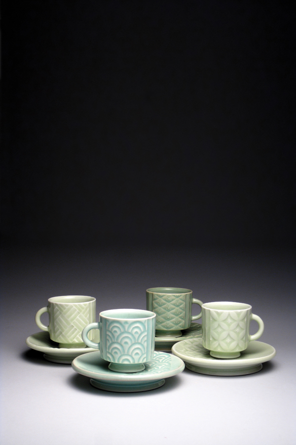 Yoshi Fujii's Cup and saucer set, 5 in. (13 cm) in height, wheel-thrown, hand-carved, and slip-trailed porcelain, celadon glazes, gas reduction fired to cone 10, 2014.