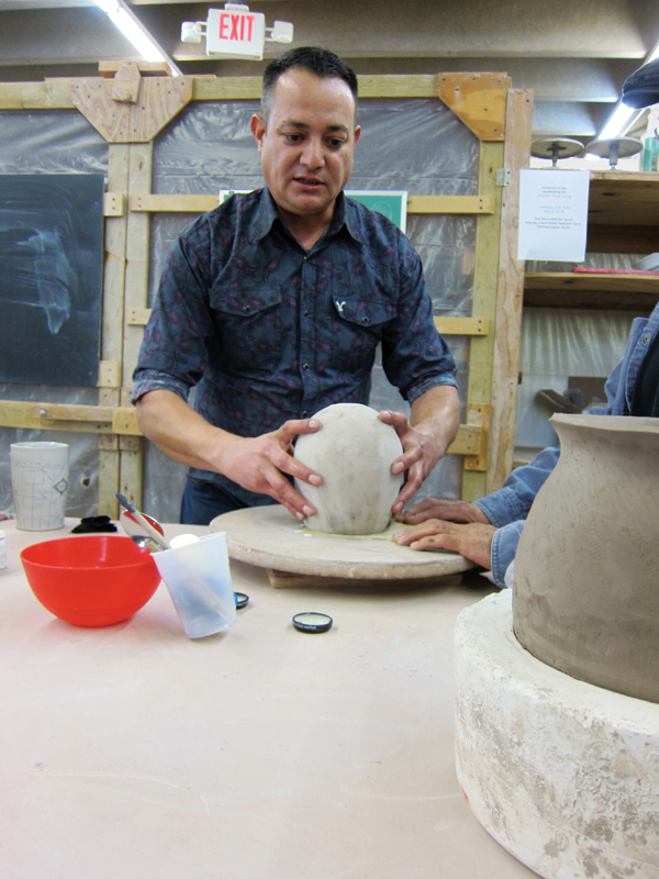 6 After the pot is bone dry, Eli sands the surface with multiple grades of sandpaper.