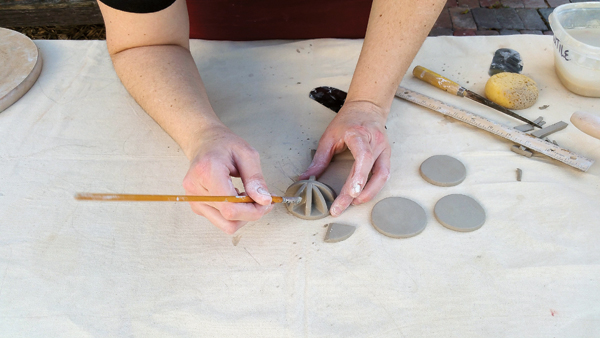 6 Use a small, stiff brush or rubber-tipped tool to clean up the attachments.